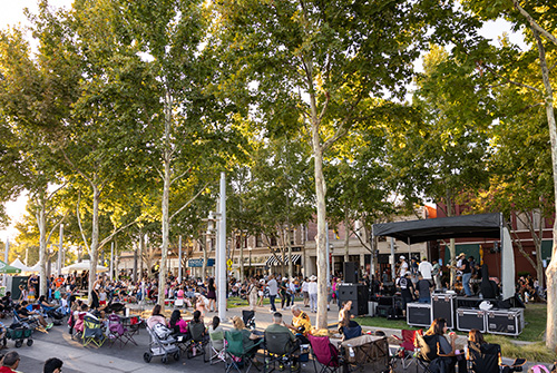 A city steet with shops and people walking