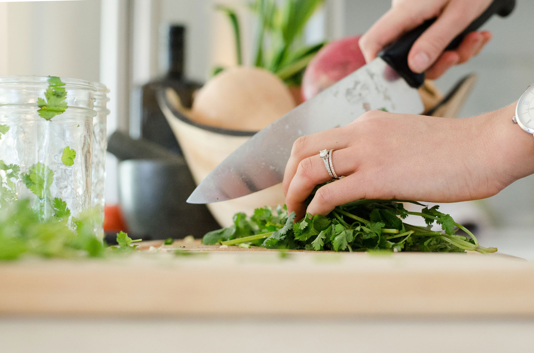Close up of hands chopping herbs