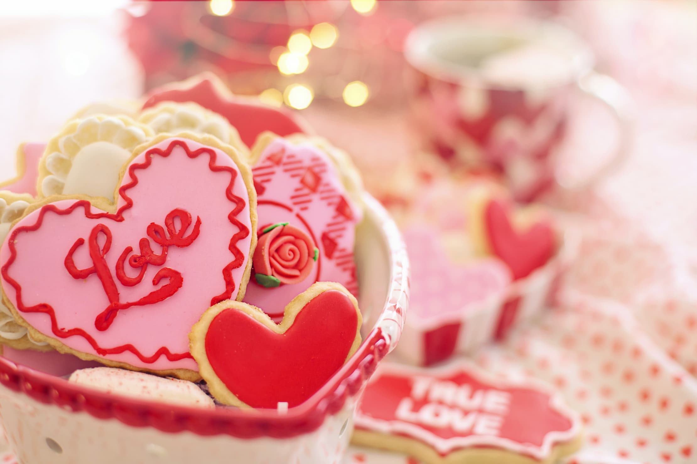 heart shaped cookies on a table with one with the word Love