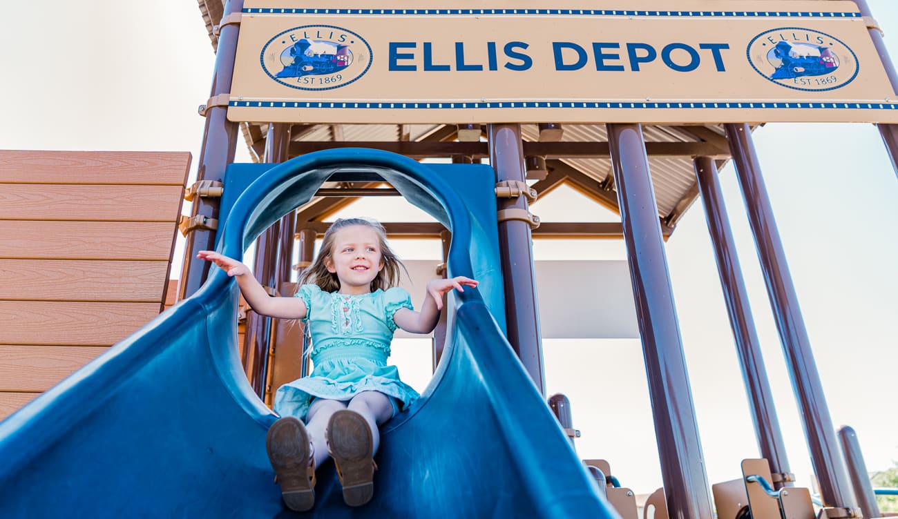 girl sliding down slide at ellis playground