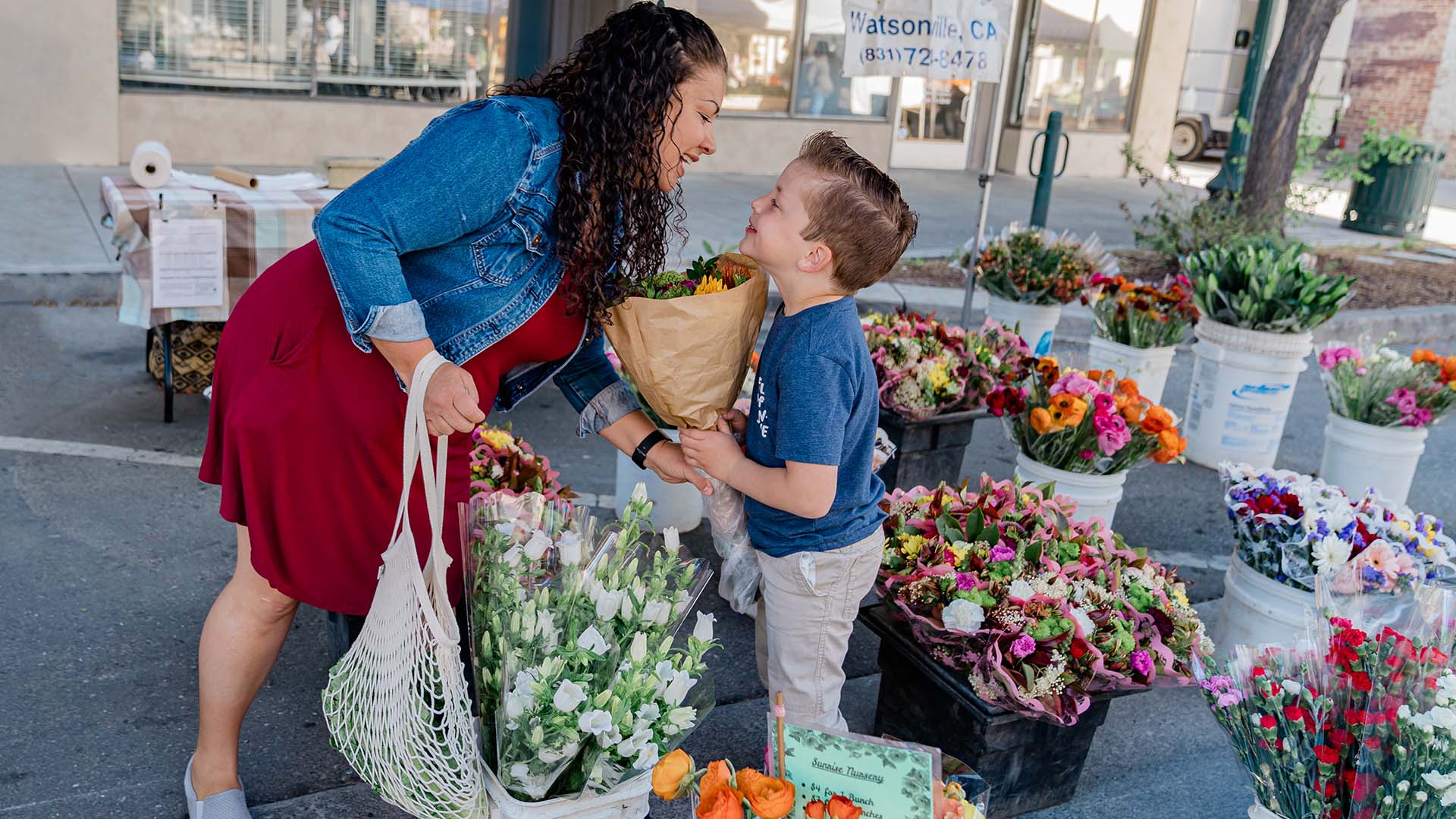 mother and son shopping for flowers