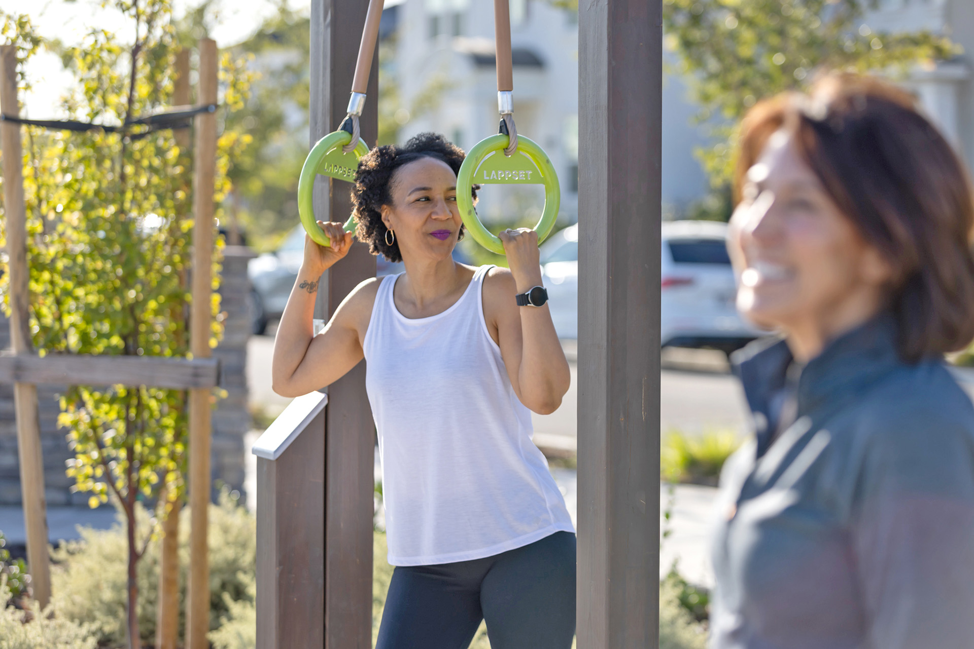 Two women working out at an outdoor gym